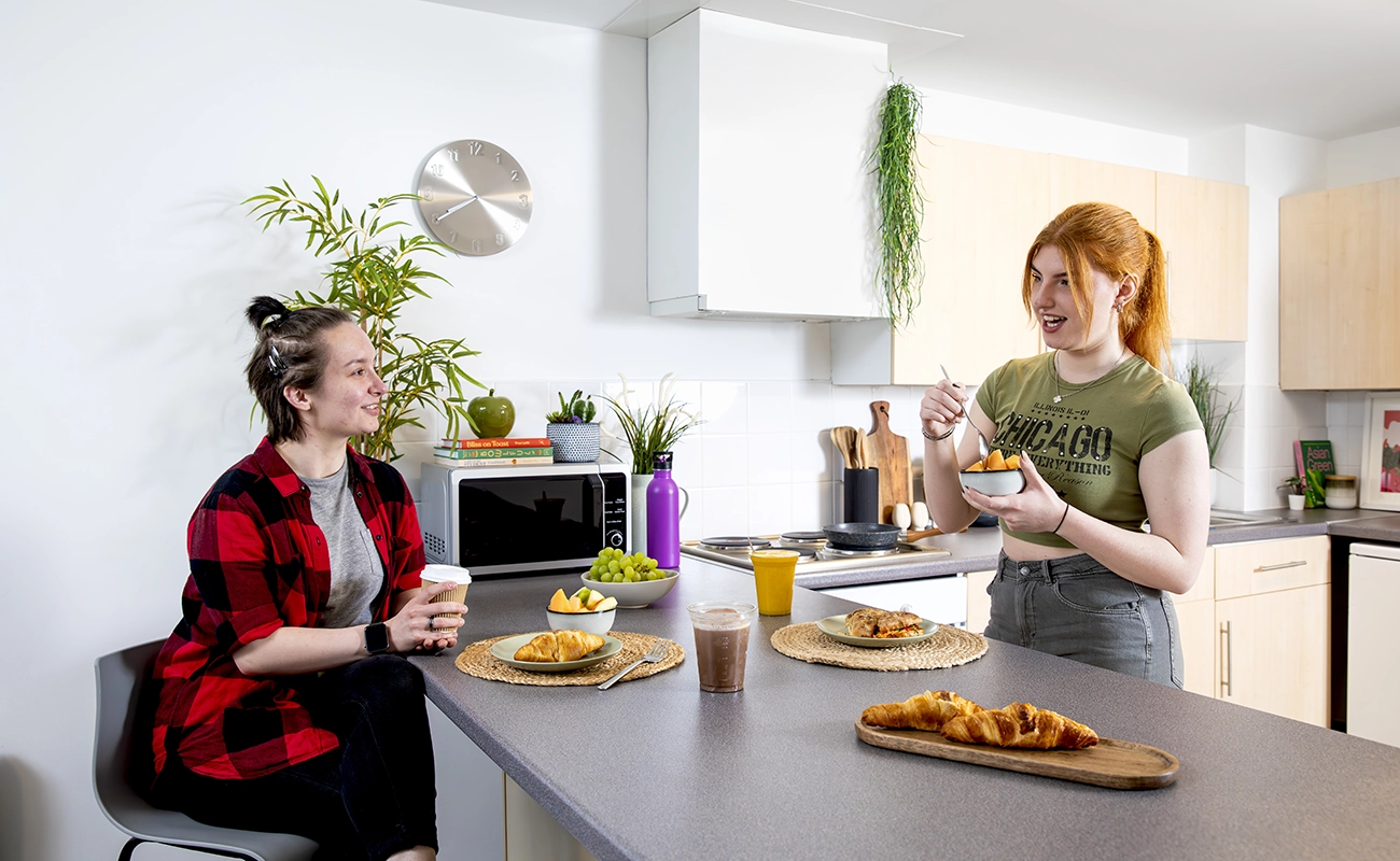 Students using the shared kitchen for ensuite rooms